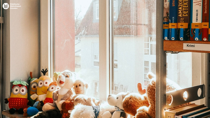 Ein Mädchen fotografiert einen Strauch mit der Kamera.
